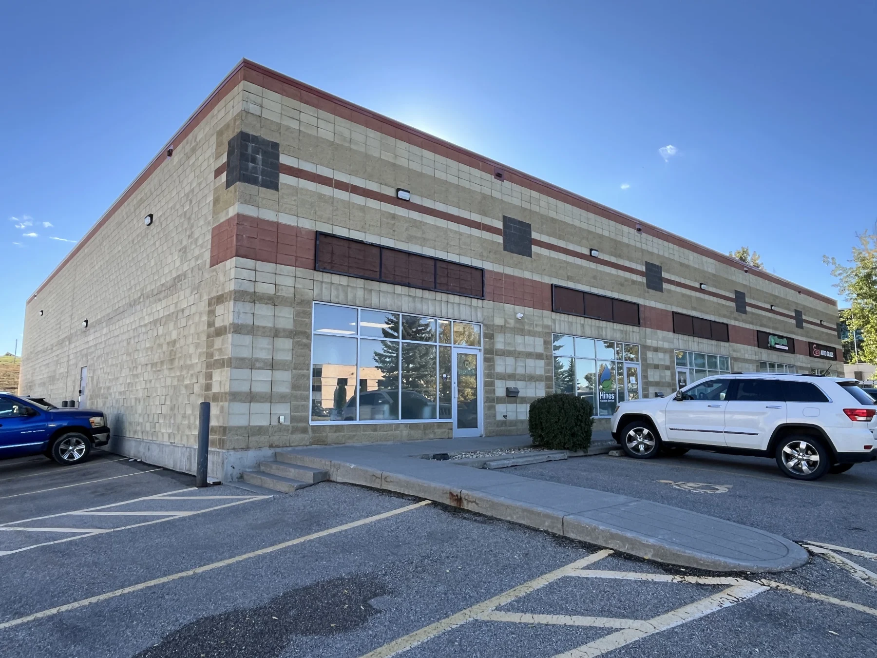 Commercial building exterior with cladding and storefront windows