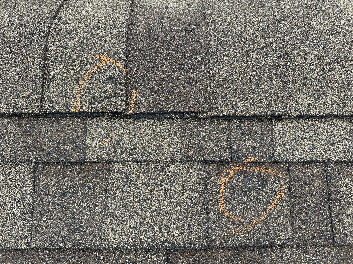 Marked areas on shingles recorded during an inspection