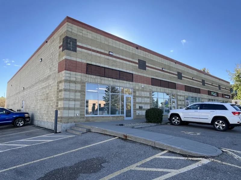 Commercial building exterior with wall cladding and storefront windows